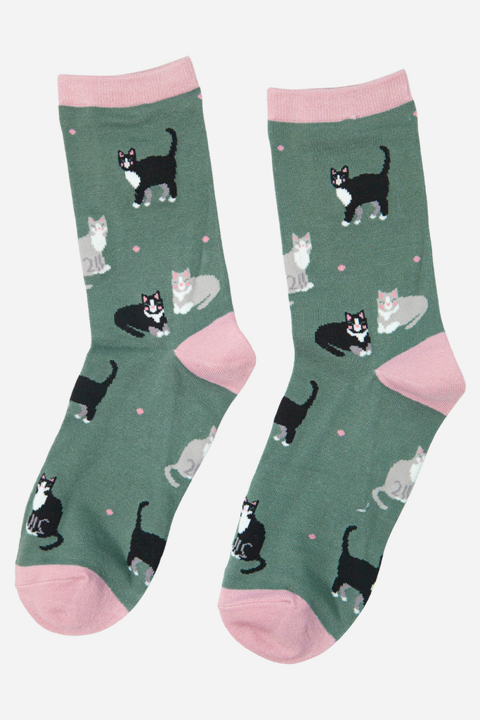 green and pink ankle socks with a pattern of grey and black cats