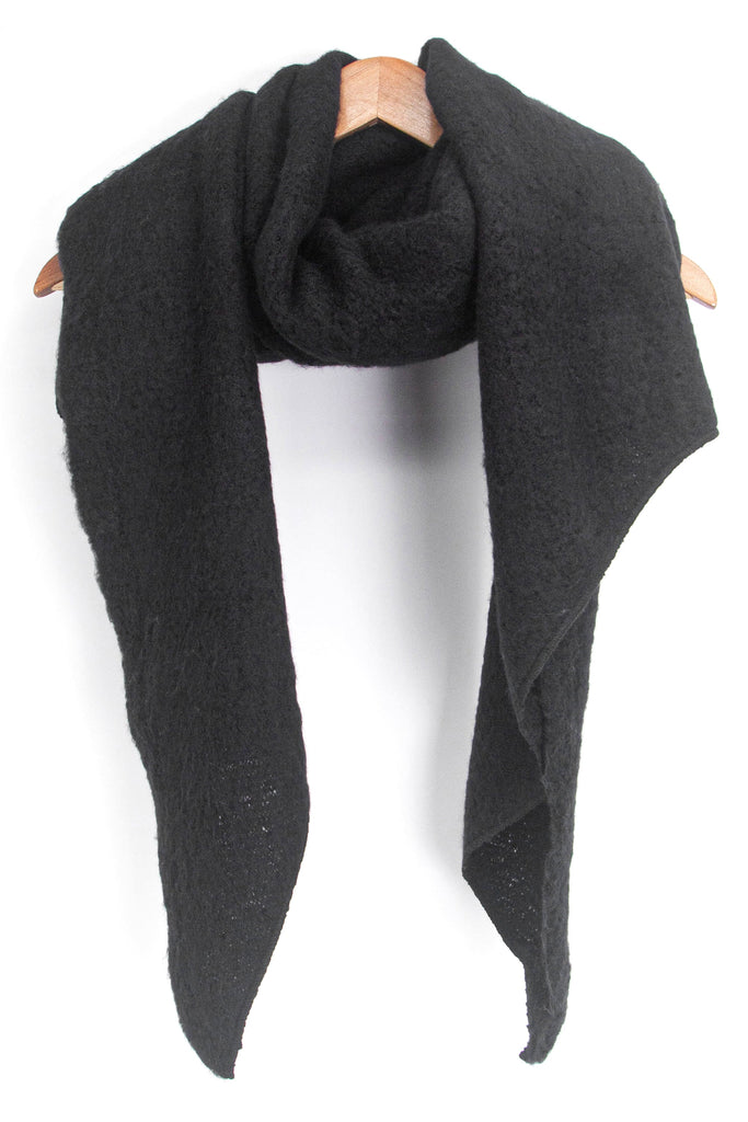 asymmetric black scarf draped around a coat hanger