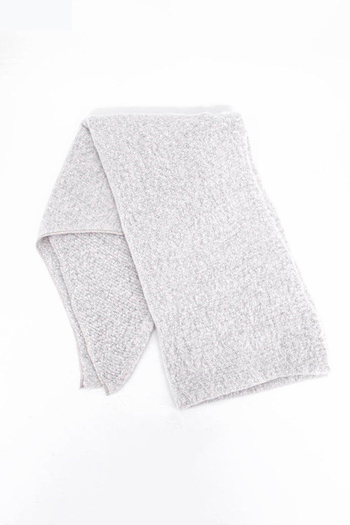 showing the scarf folded highlighting the solid light grey colour