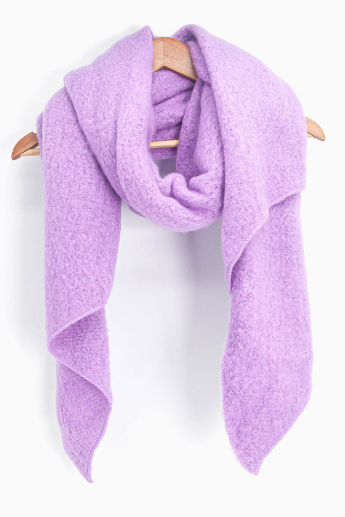 asymmetric lilac scarf draped around a coat hanger