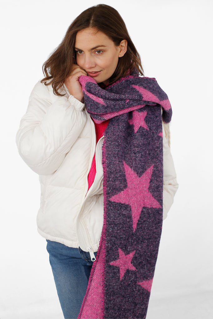 model wearing a navy blue and pink star print winter scarf