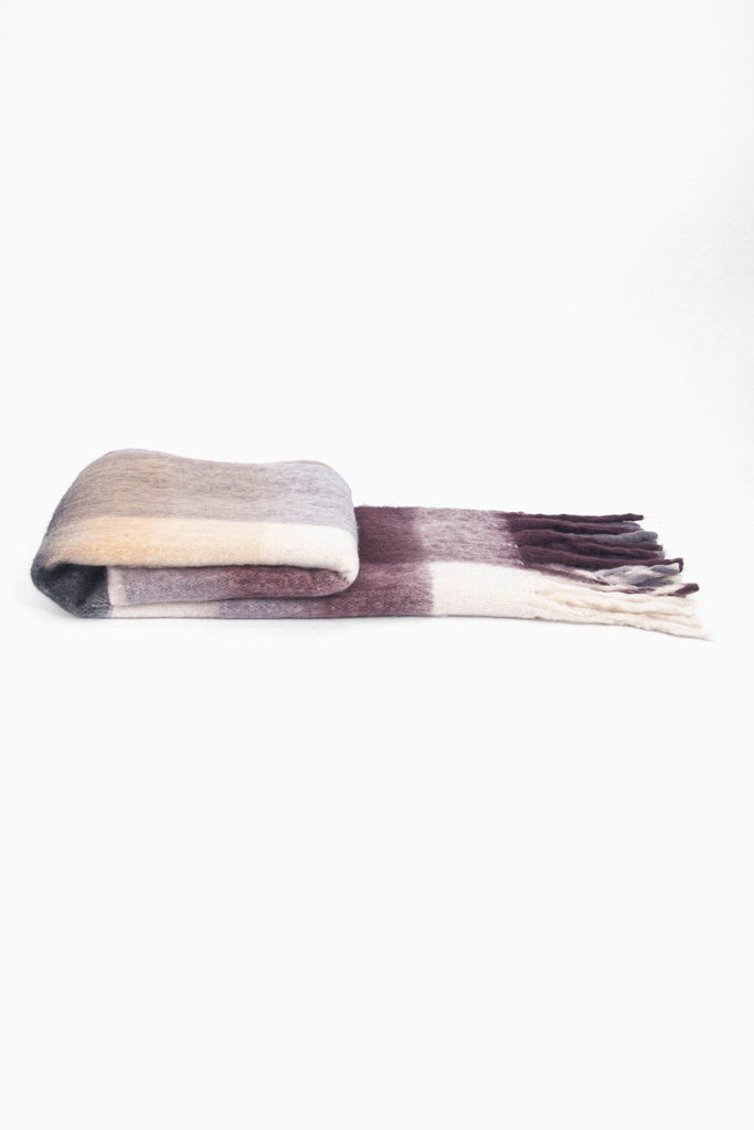 side view of the scarf when folder, showing the texture and thickness of the material. this scarf is warm and winter weight