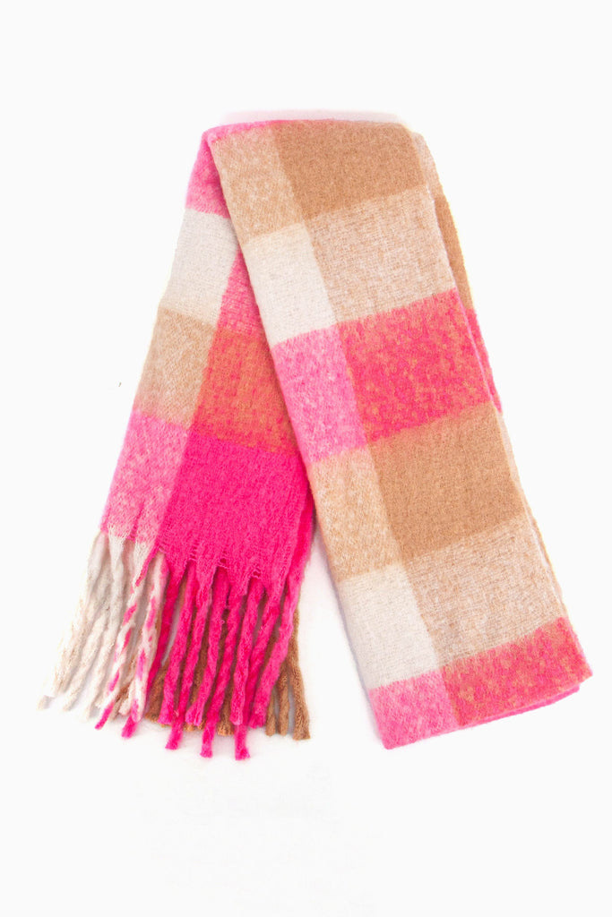 showing the scarf folded while laying flat, the multi colour  square block pattern is highlighted. there are pink, cream and beige tones visible in the design.