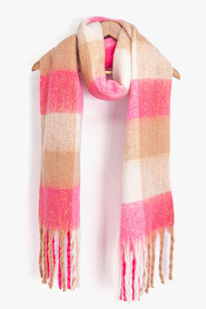 showing the multicoloured square colour block winter scarf draped around a coat hanger, showing how it would look when worn.