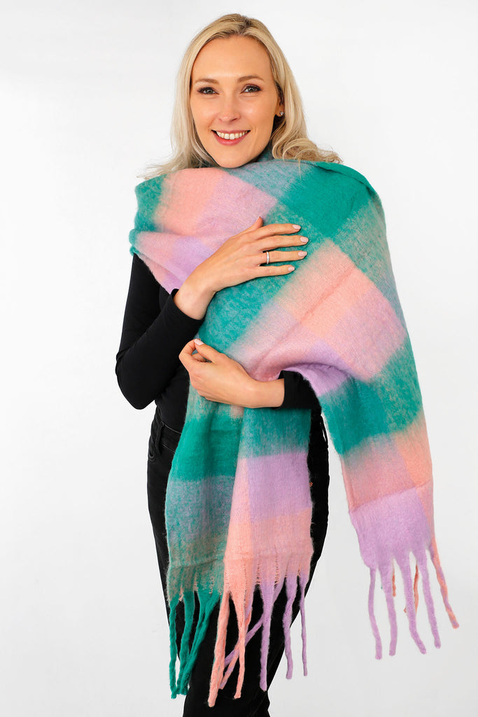 model wearing a green and lilac check pattern winter scarf with tassles