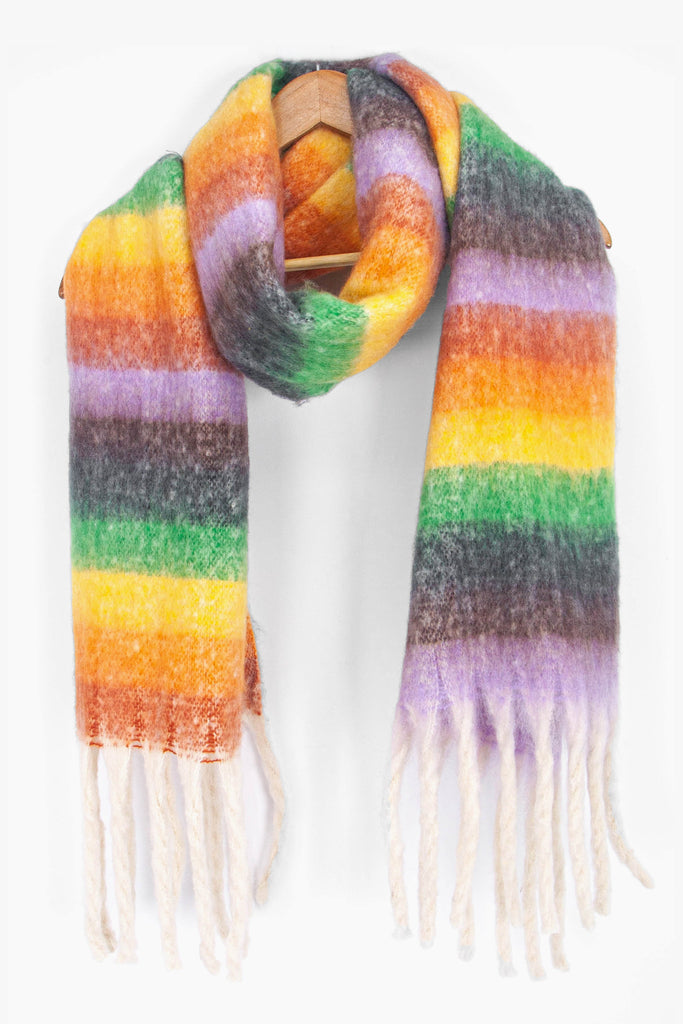 showing the multicoloured rainbow stripe winter scarf draped around a coat hanger, showing how it would look when worn.