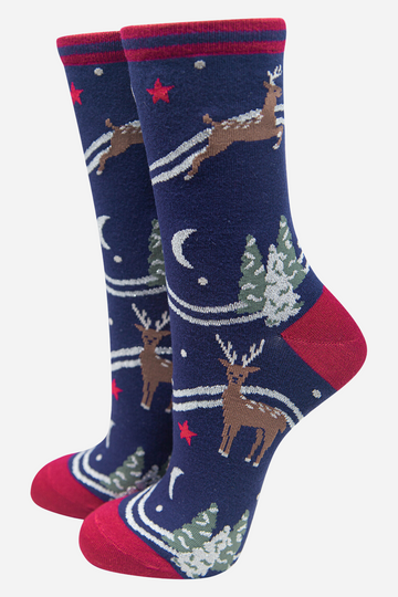 navy blue ankle socks with reindeer, snow covered xmas trees and stars and moons