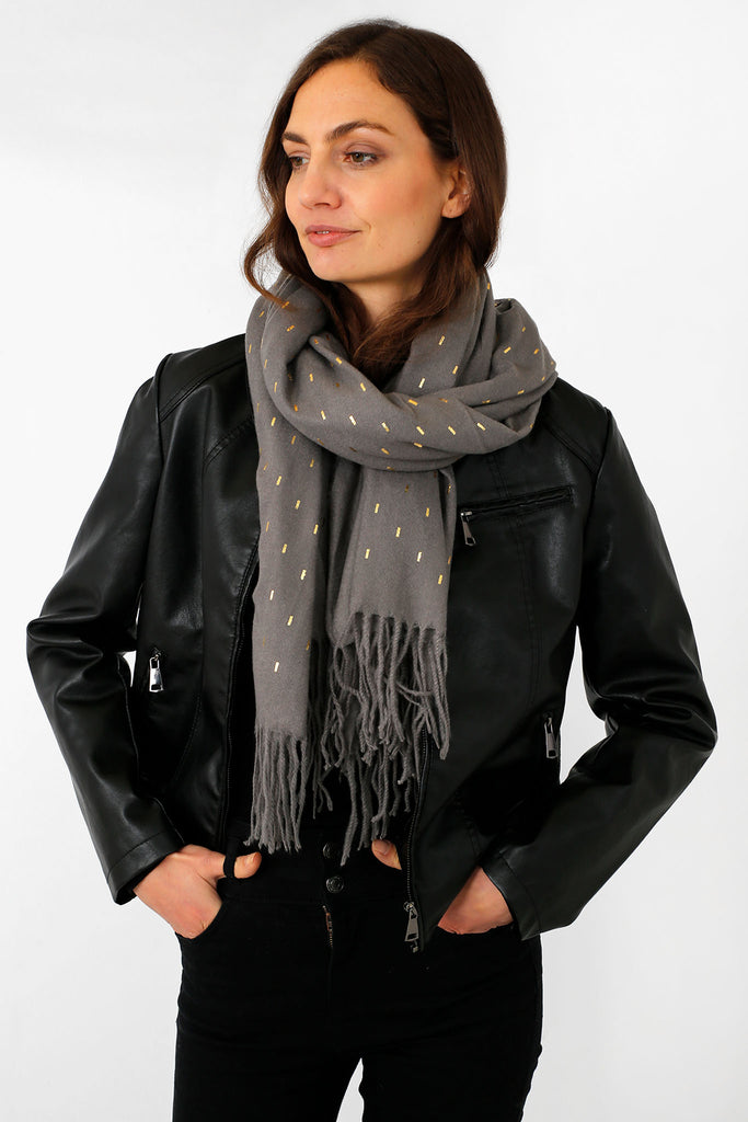 model wearing a grey winter scarf with a gold foil matchstick pattern
