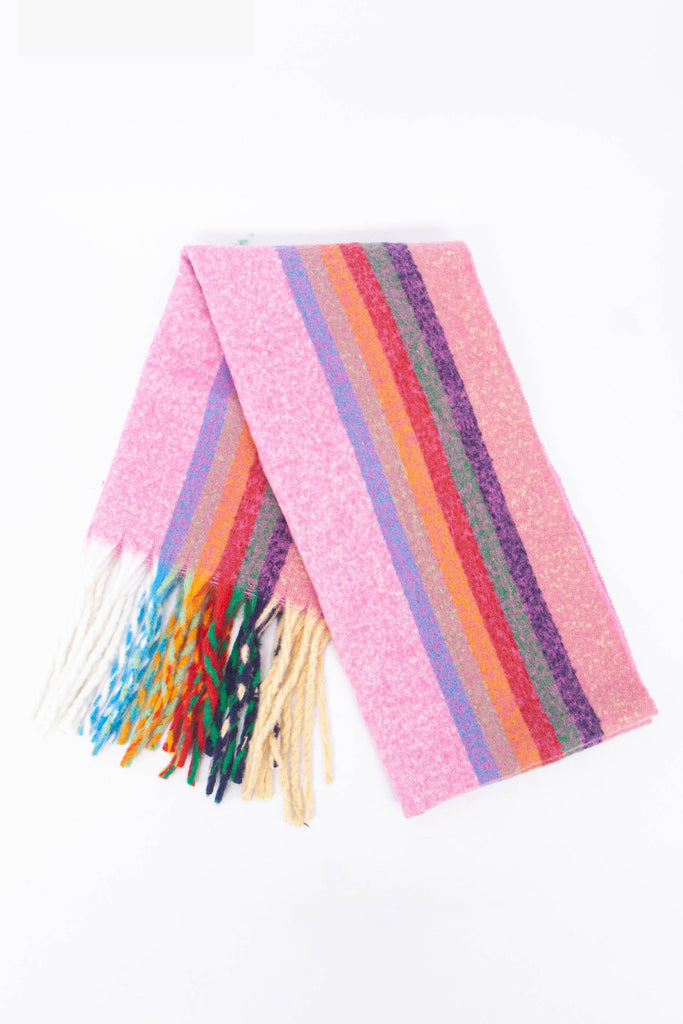 showing the scarf folded while laying flat, the multi colour rainbow stripe pattern is highlighted. there are pink, orange, green, purple and blue tones visible in the design.