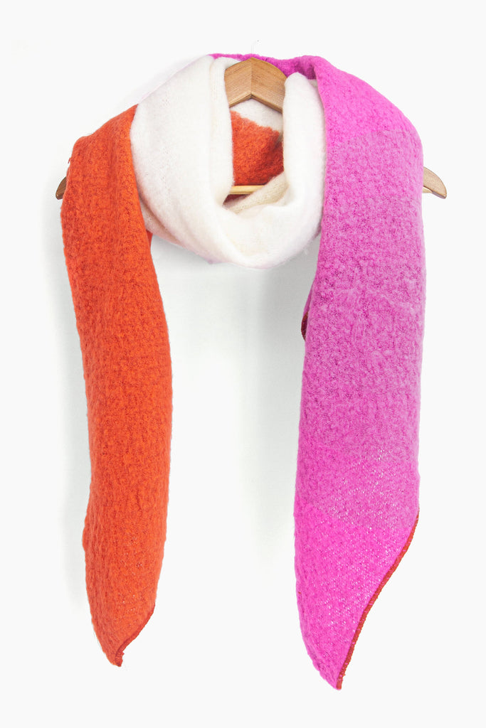 showing the asymmetrical colour block winter scarf draped around a coat hanger, showing how it would look when worn.