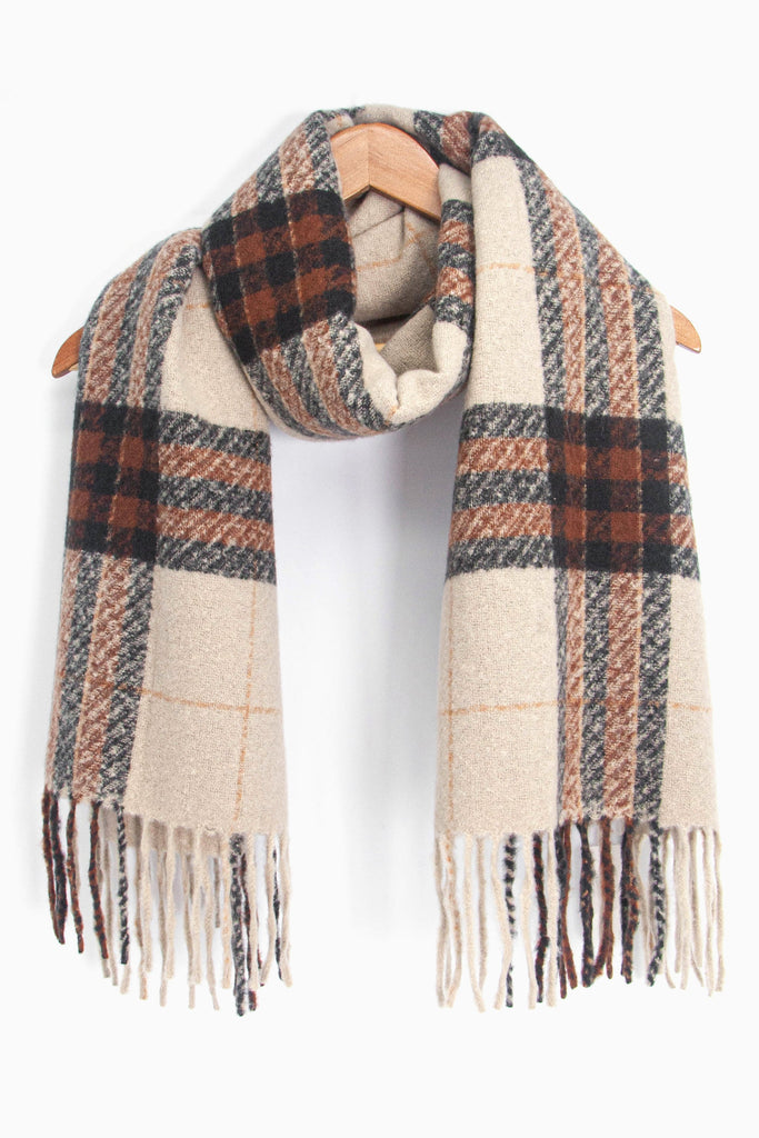 showing the camel beige and brown plaid pattern winter scarf draped around a coat hanger, showing how it would look when worn.