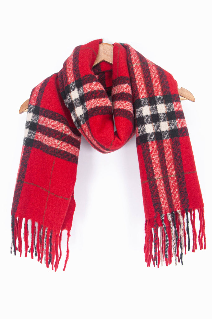 showing the red plaid pattern winter scarf draped around a coat hanger, showing how it would look when worn.