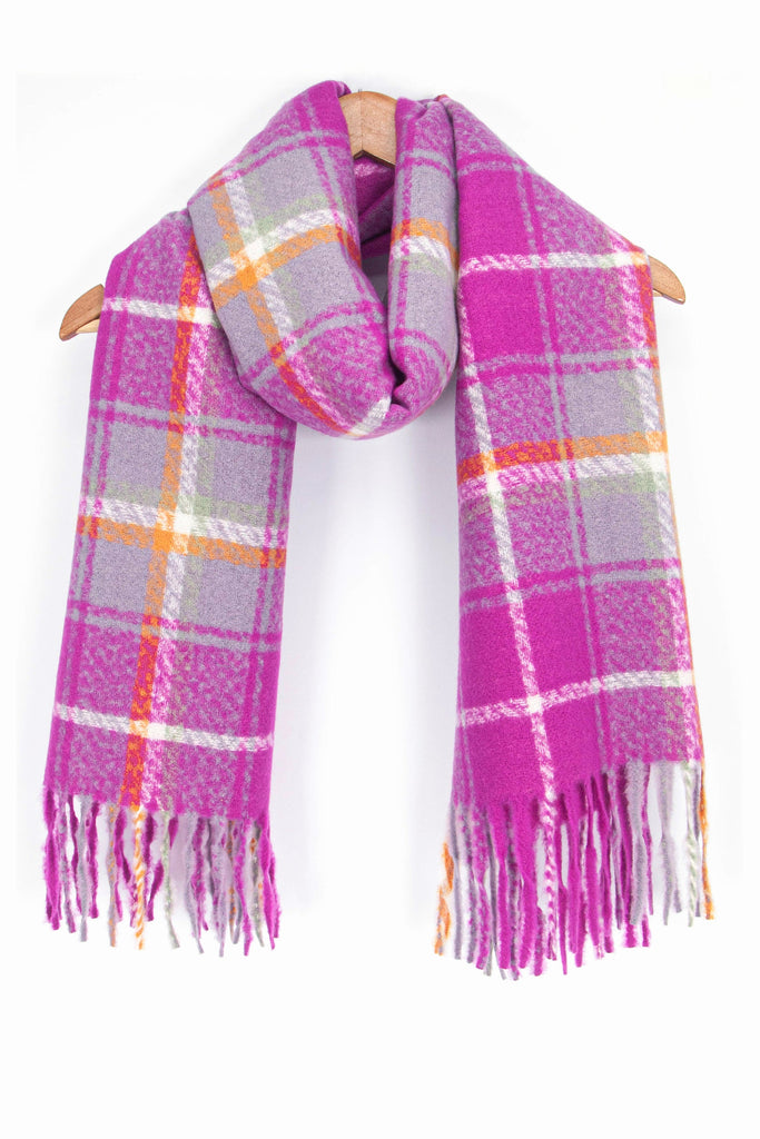 showing the violet, white and yellow plaid pattern winter scarf draped around a coat hanger, showing how it would look when worn.
