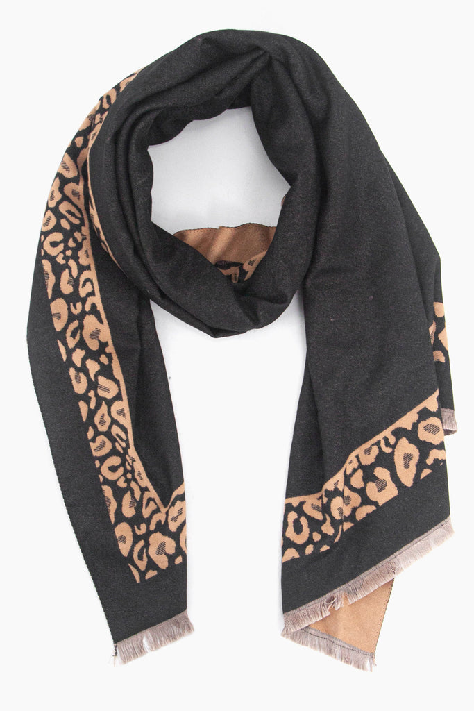 black winter scarf with a neutral leopard print border and beige fringed edge