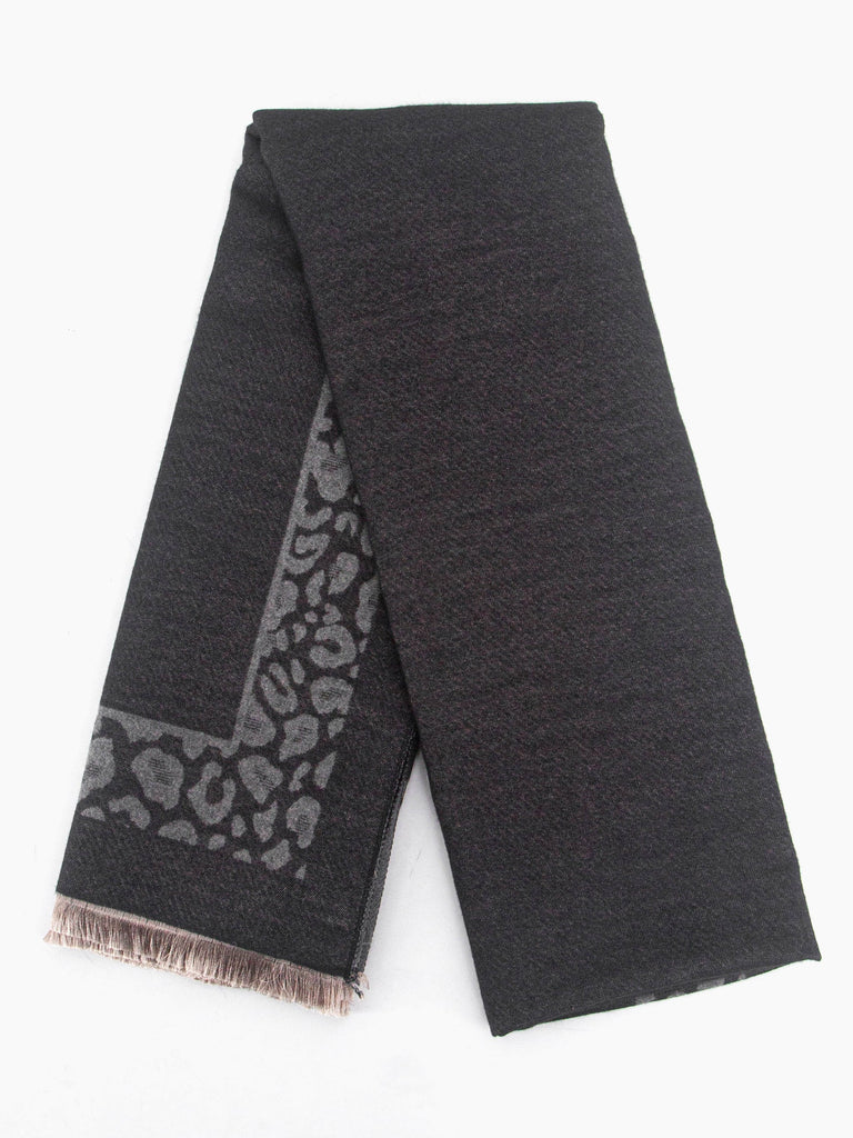 showing the scarf folded flat, the leopard print border is clearly visible and contrasts the plain black background