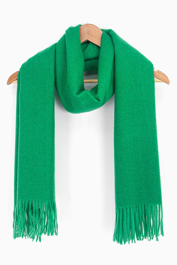 showing the bright green winter scarf draped around a coat hanger