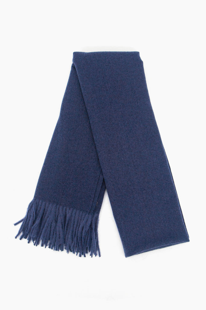 showing the scarf folded while laying flat, the plain navy blue design is shown