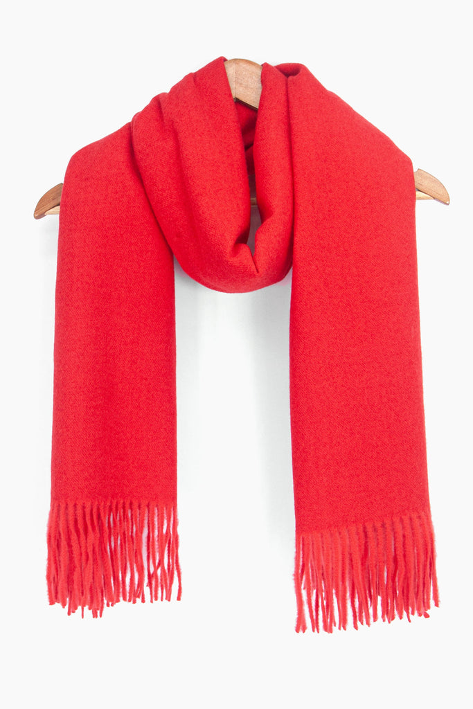 showing the plain red winter scarf draped around a coat hanger