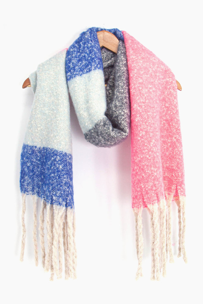 showing the grey, pink and blue colour block winter scarf draped around a coat hanger, showing how it would look when worn.