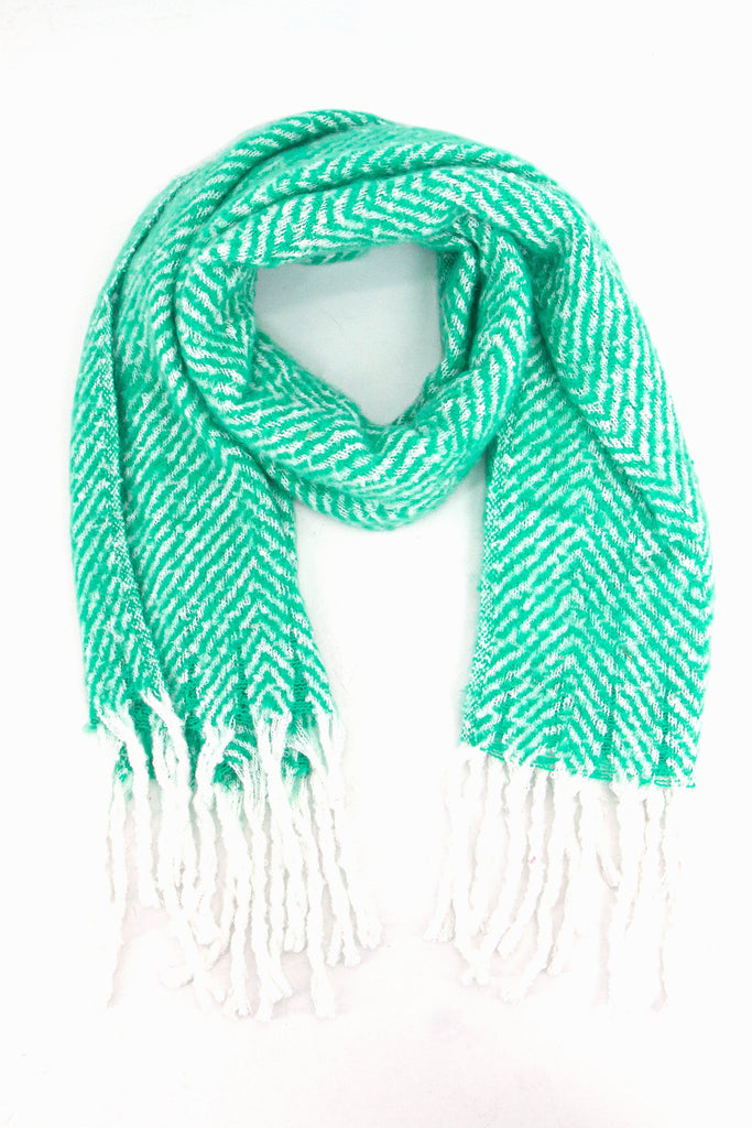 green herringbone pattern knitted winter scarf with a contrasting white tassel trim