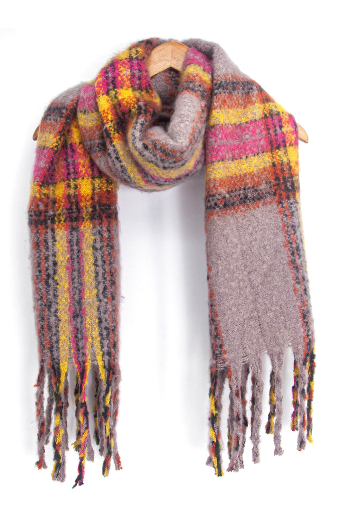 showing the grey traditional checked pattern winter scarf draped around a coat hanger, showing how it would look when worn.