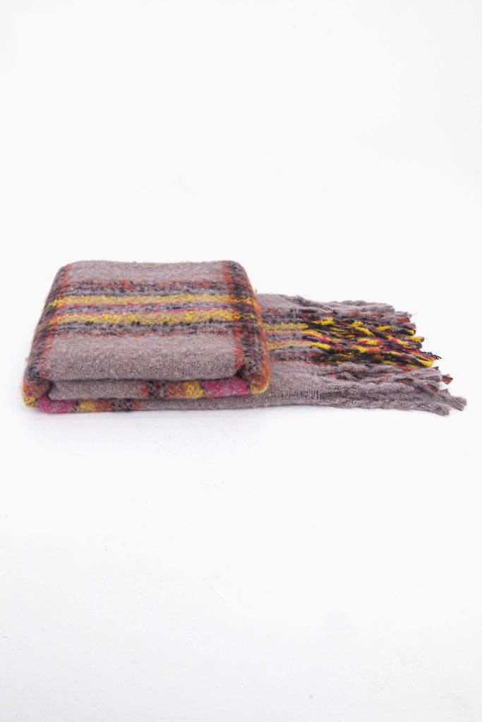 side view of the scarf when folder, showing the texture and thickness of the material. this scarf is warm and winter weight