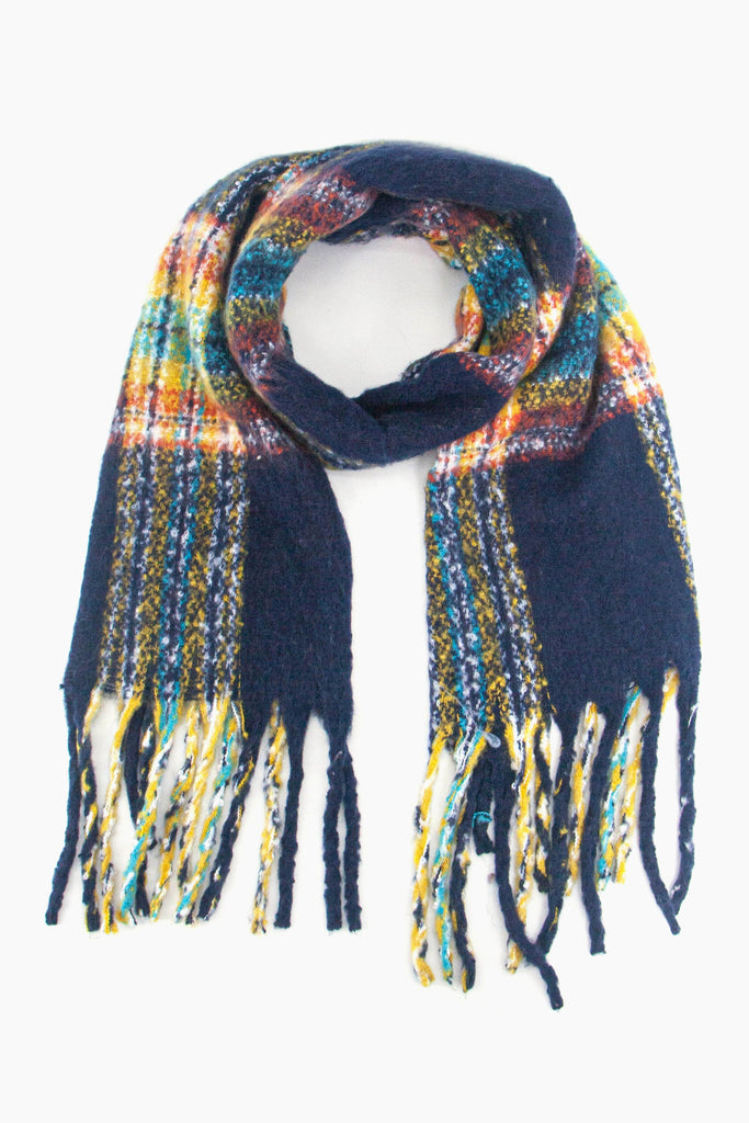 navy blue scarf with a multi-coloured tartan plaid pattern, the scarf has a tasselled fringe edge