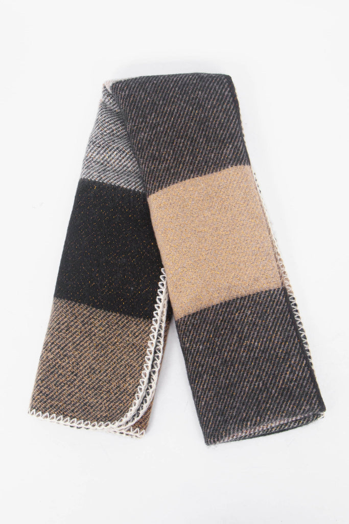 showing the scarf folded while laying flat, the square check block pattern is highlighted and shows the black, beige and grey colourways.