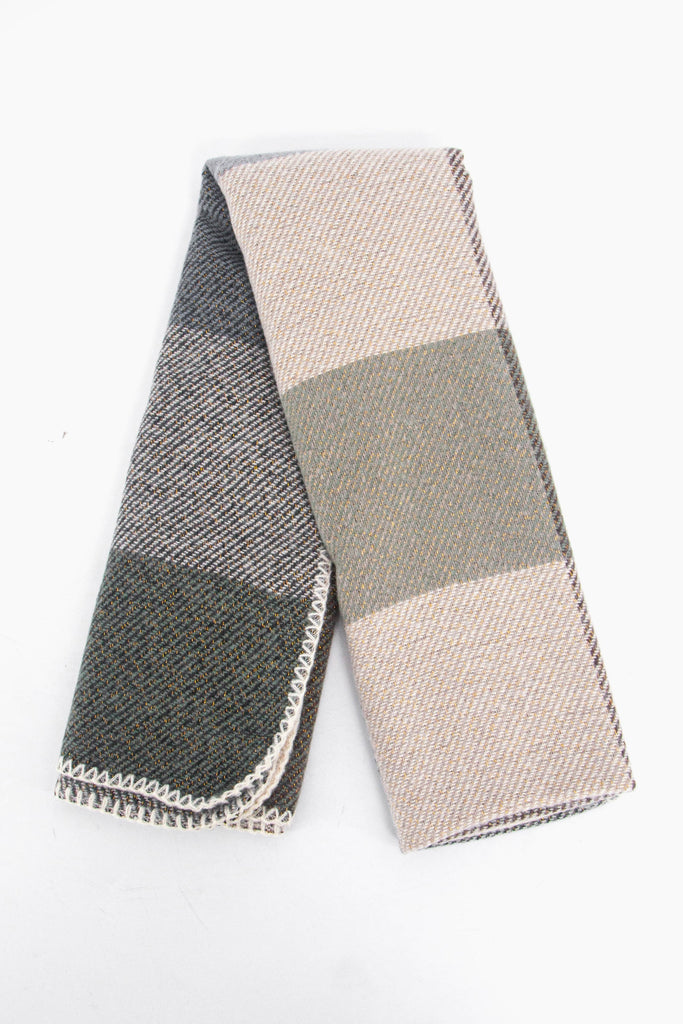 showing the scarf folded while laying flat, the square check block pattern is highlighted and shows the blue, beige and grey colourways.