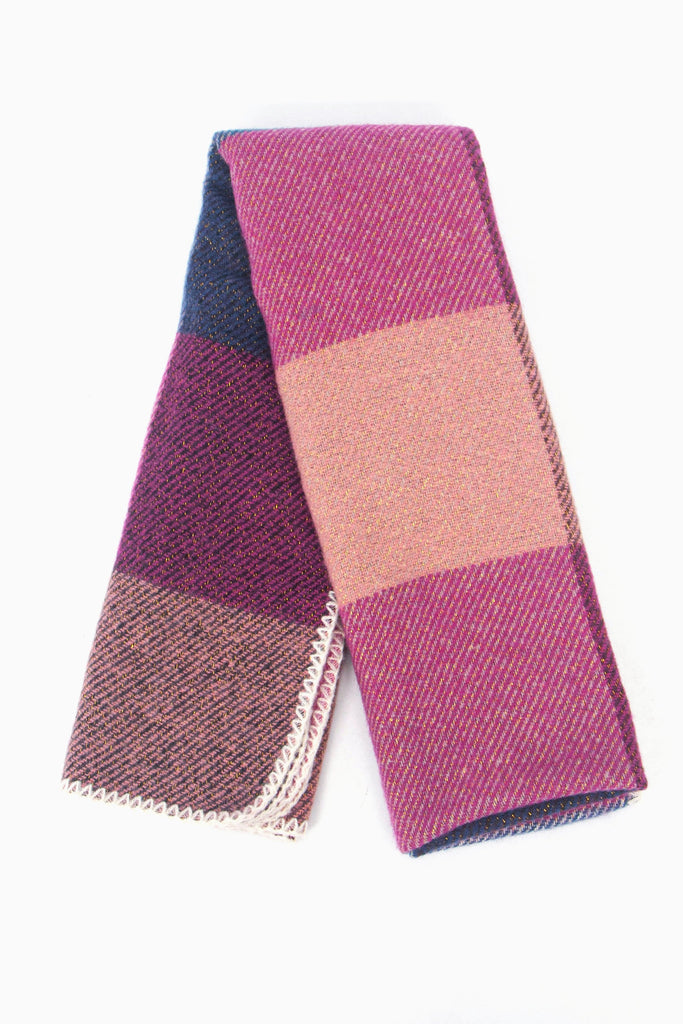 showing the scarf folded while laying flat, the square check block pattern is highlighted and shows the pink, fuchsia and navy colourways.