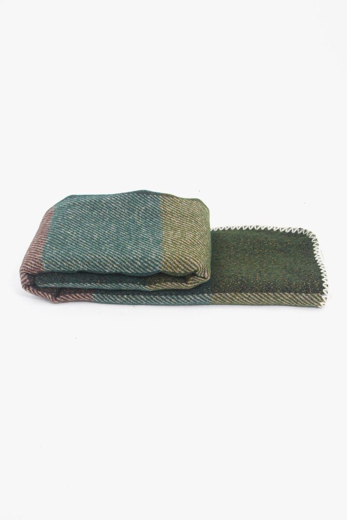 side view of the scarf when folder, showing the texture and thickness of the material. this scarf is warm and winter weight