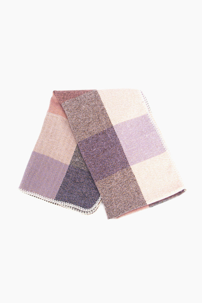 showing the scarf folded while laying flat, the square check block pattern is highlighted and shows the red, pink and cream colourways.