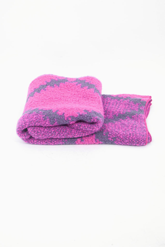 side view of the scarf when folded, showing the texture and thickness of the material. this scarf is warm and winter weight