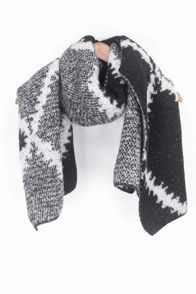 showing the black and grey cross hatch pattern winter scarf draped around a coat hanger, showing how it would look when worn.