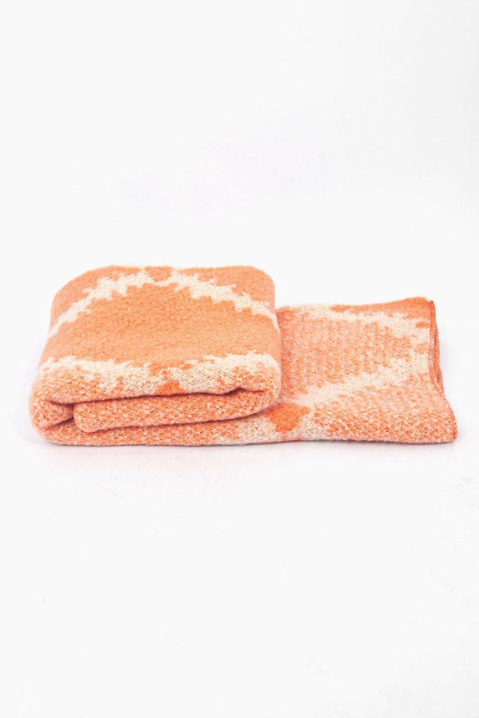 side view of the scarf when folded, showing the texture and thickness of the material. this scarf is warm and winter weight