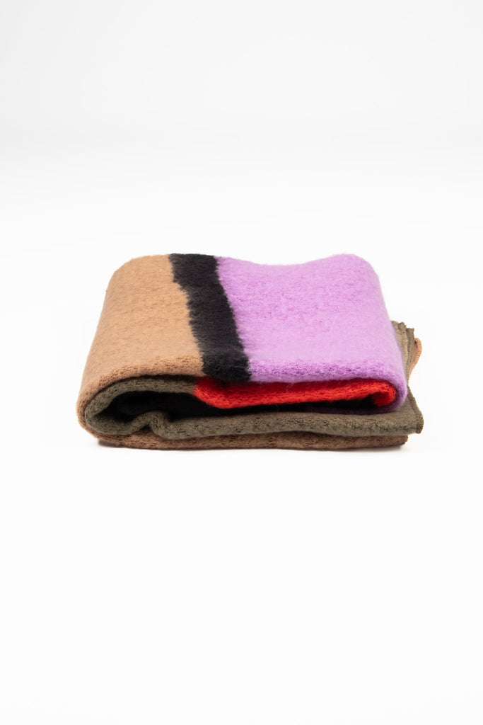 side view of the scarf when folder, showing the texture and thickness of the material. this scarf is warm and winter weight