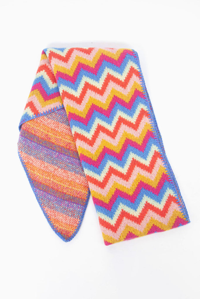 showing the scarf folded while laying flat, the multicoloured zig zag pattern is clearly highlighted.