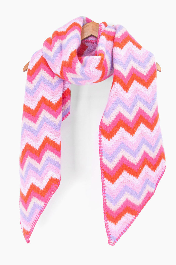 showing the multicoloured pink and lilac zig zag pattern winter scarf draped around a coat hanger, showing how it would look when worn.