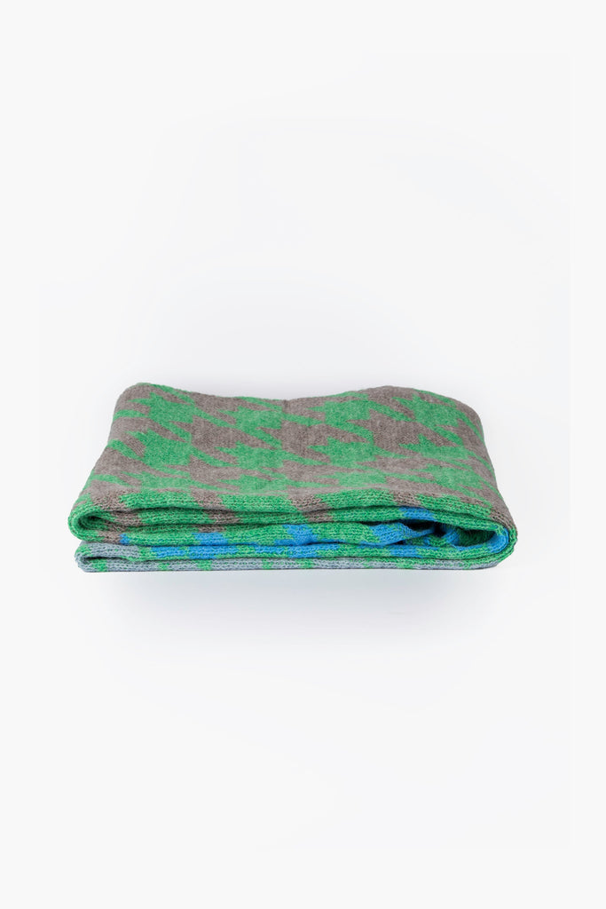 side view of the scarf when folder, showing the texture and thickness of the material. this scarf is warm and winter weight