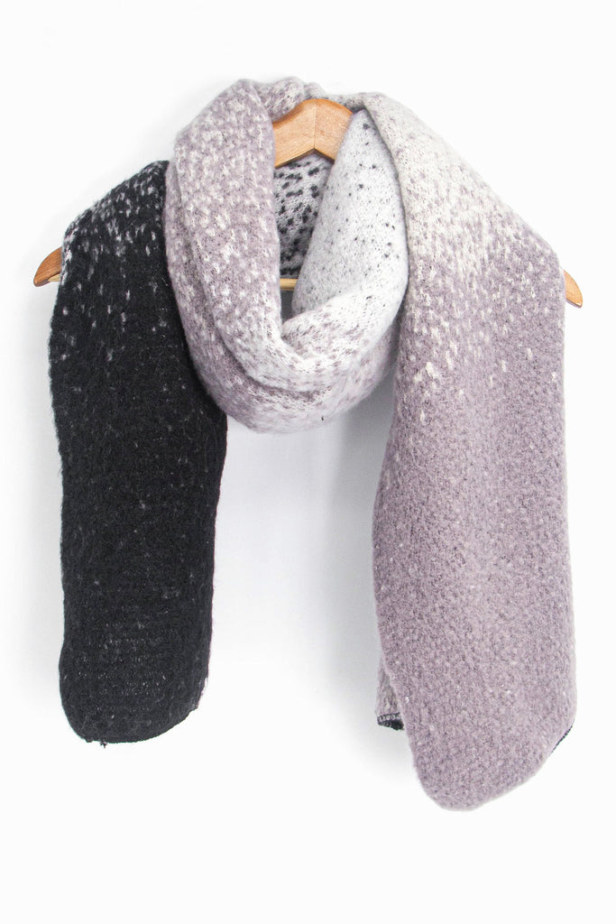 showing the grey ombre winter scarf draped around a coat hanger, showing how it would look when worn.