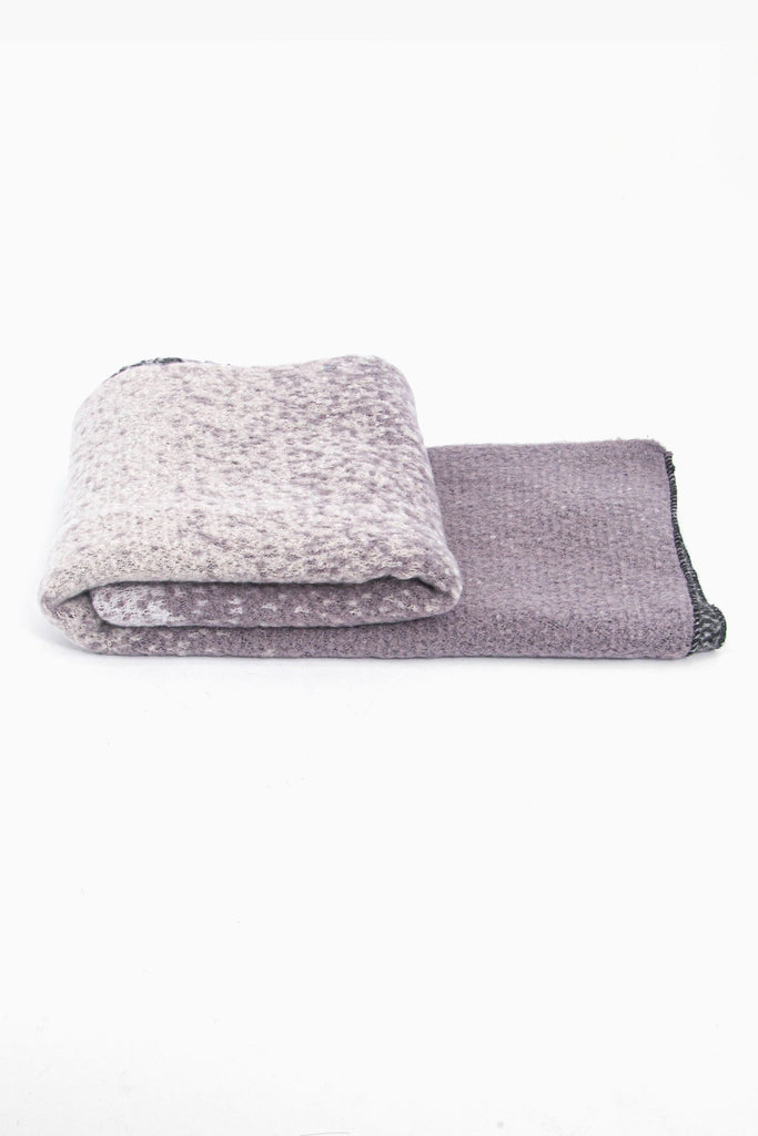 side view of the scarf when folded, showing the texture and thickness of the material. this scarf is warm and winter weight