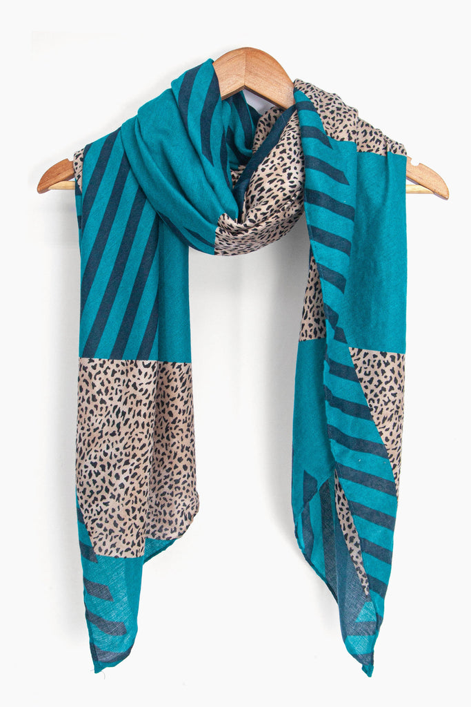 showing the scarf draped around a coat hanger, showing the all over pattern and how it would look when worn