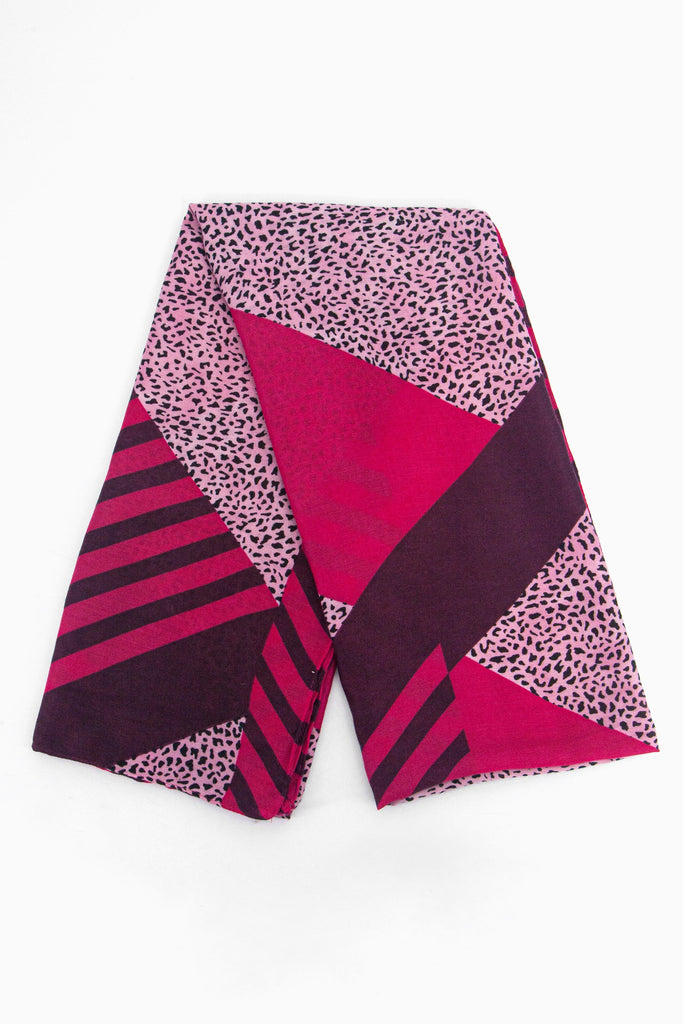 showing the scarf folded, showing the fuchsia pink background, animal stripes and pink animal print blocks on the design