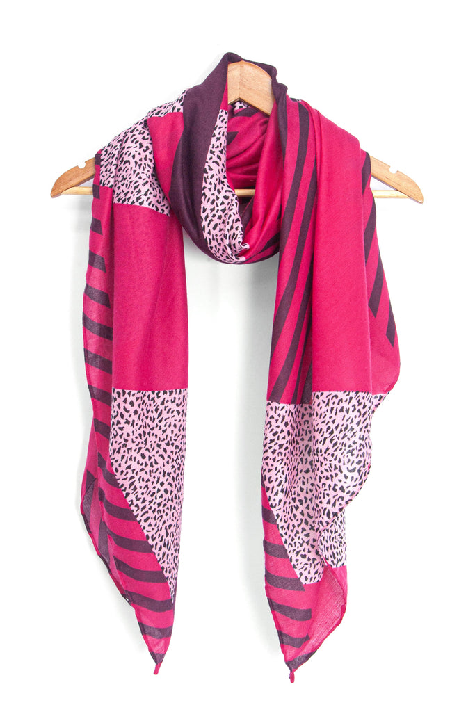showing the scarf draped around a coat hanger, showing the all over pattern and how it would look when worn