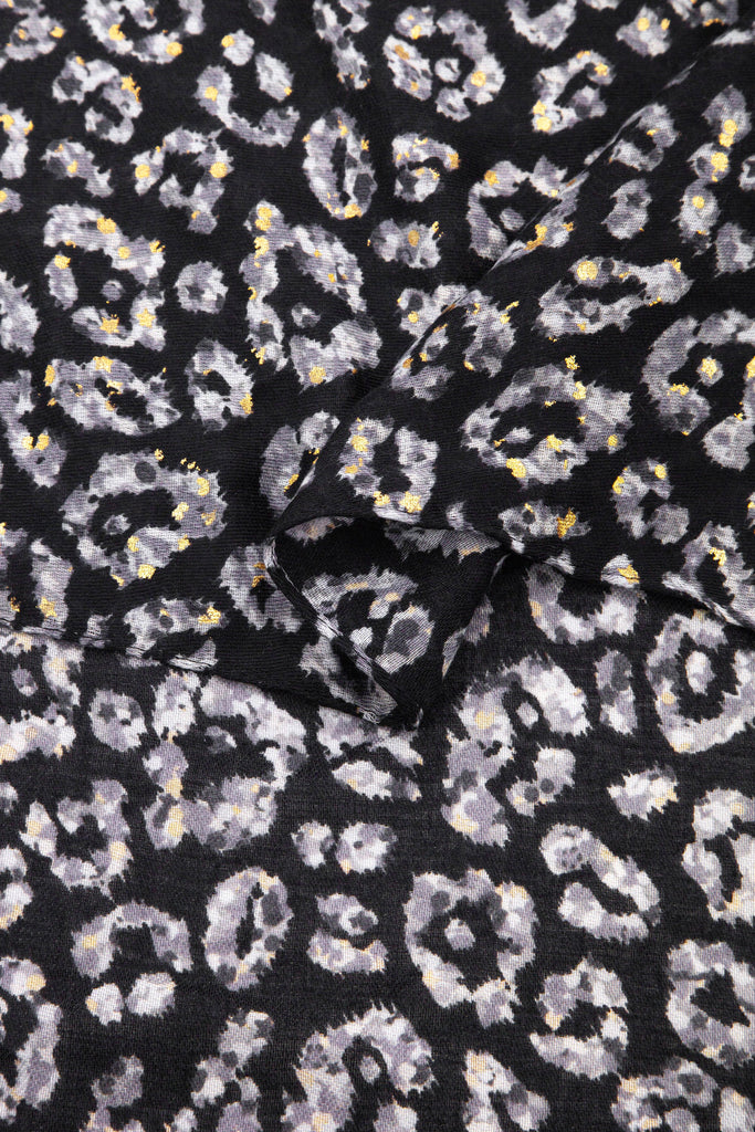 close up of the soft viscose fabric, the blue leopard print colourway is clearly visible