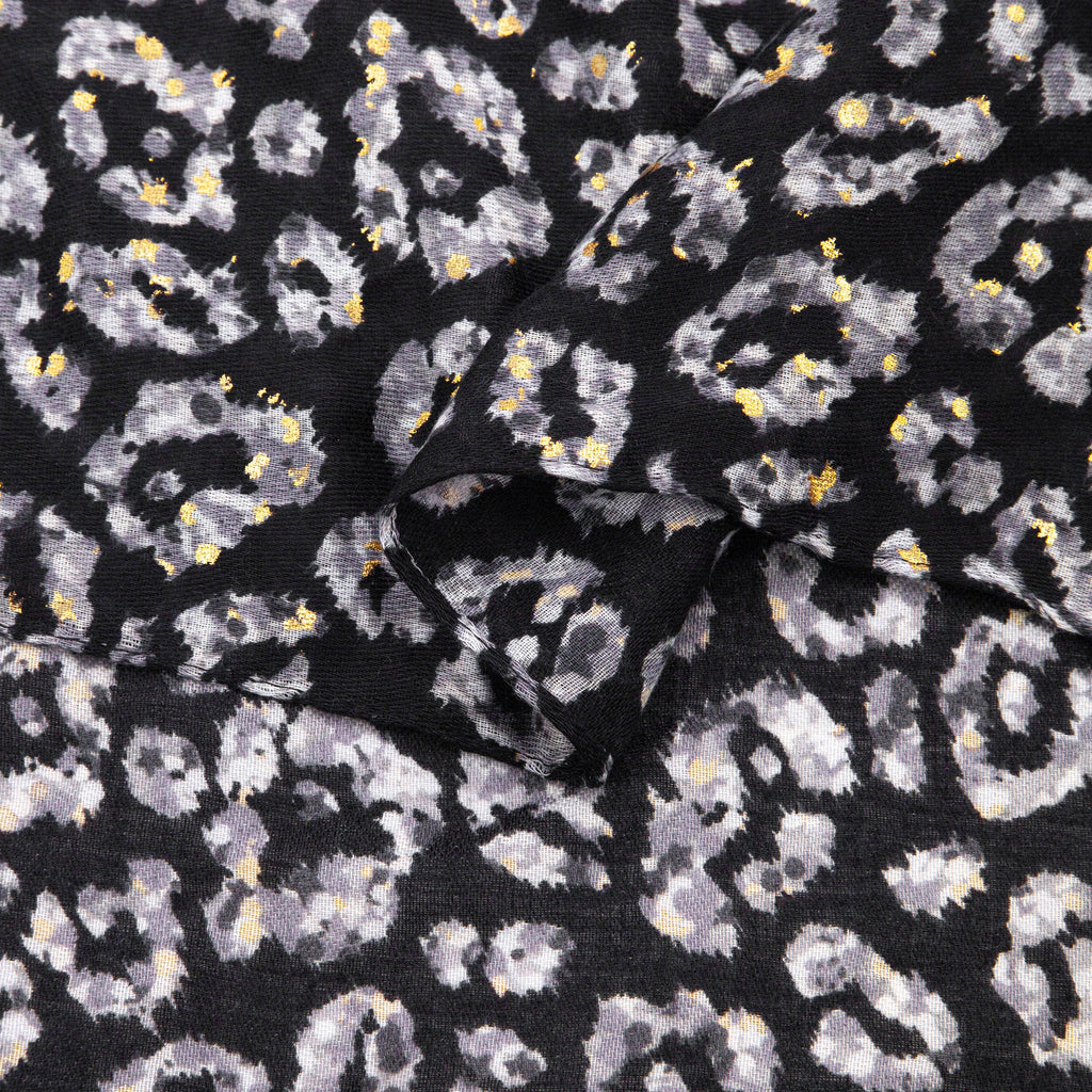 close up of the soft viscose fabric, the blue leopard print colourway is clearly visible