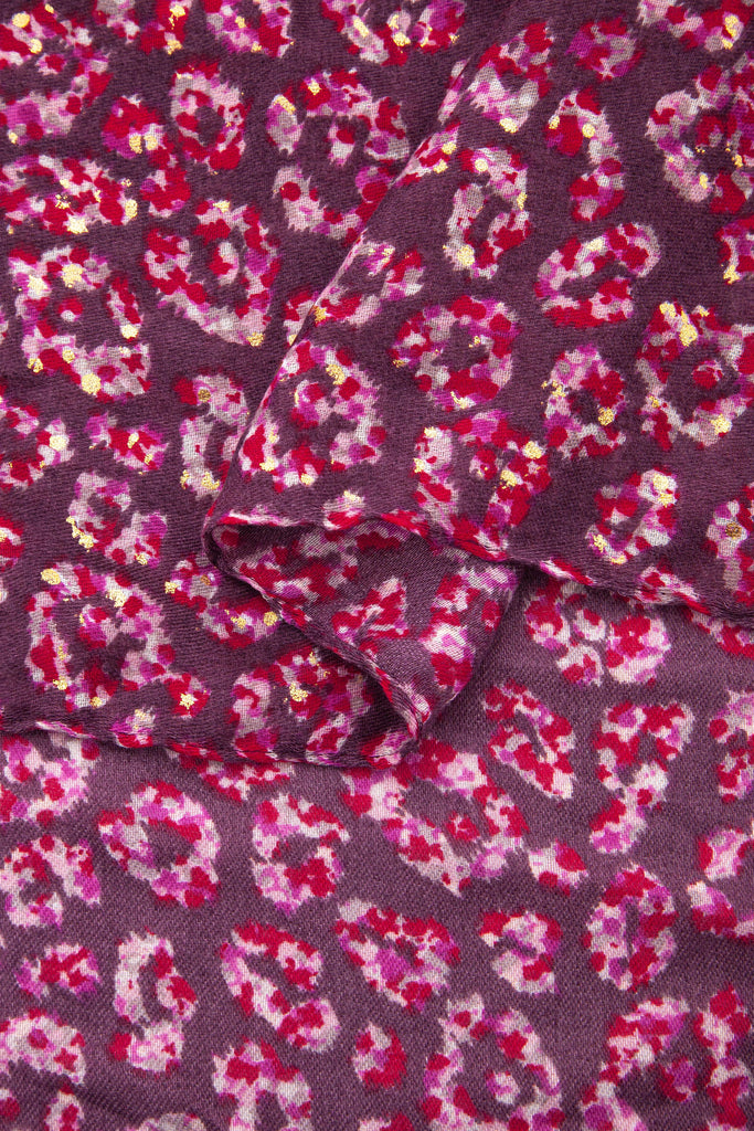 close up of the soft viscose fabric, the pink leopard print colourway is clearly visible