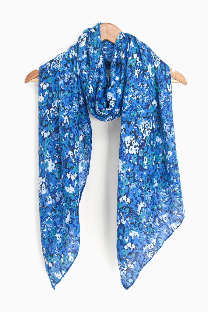 showing the scarf draped around a coat hanger, showing the all over pattern and how it would look when worn