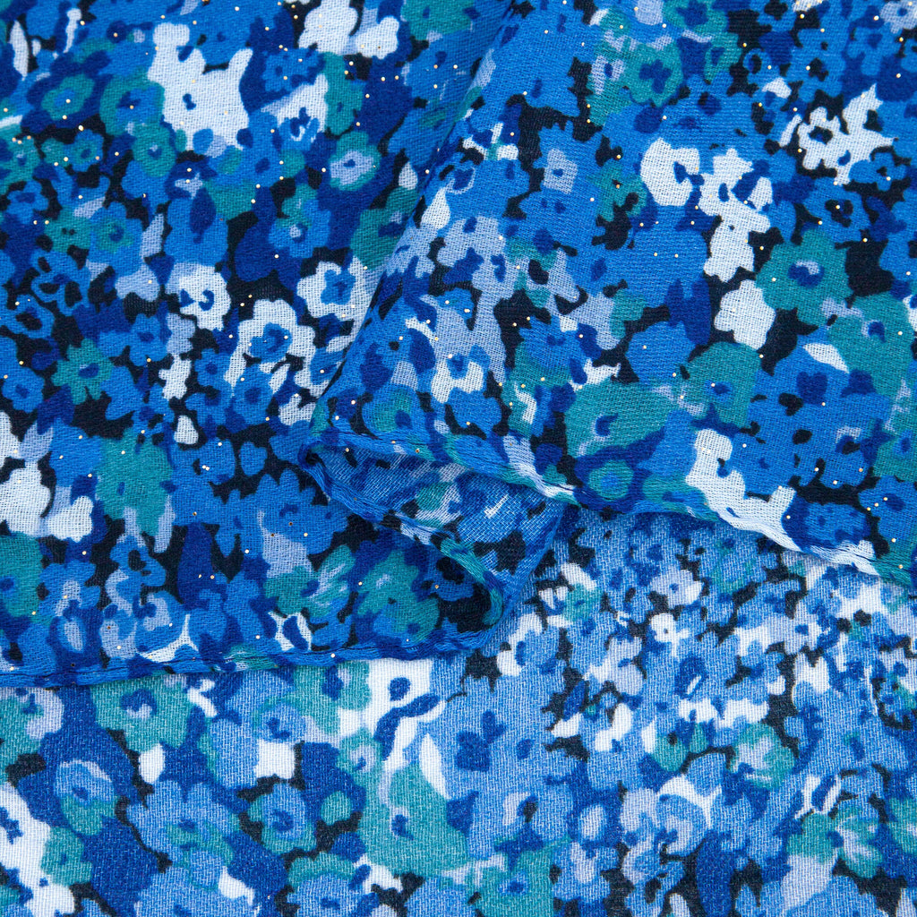 close up of the soft viscose fabric, the blue floral print pattern is are clearly visible