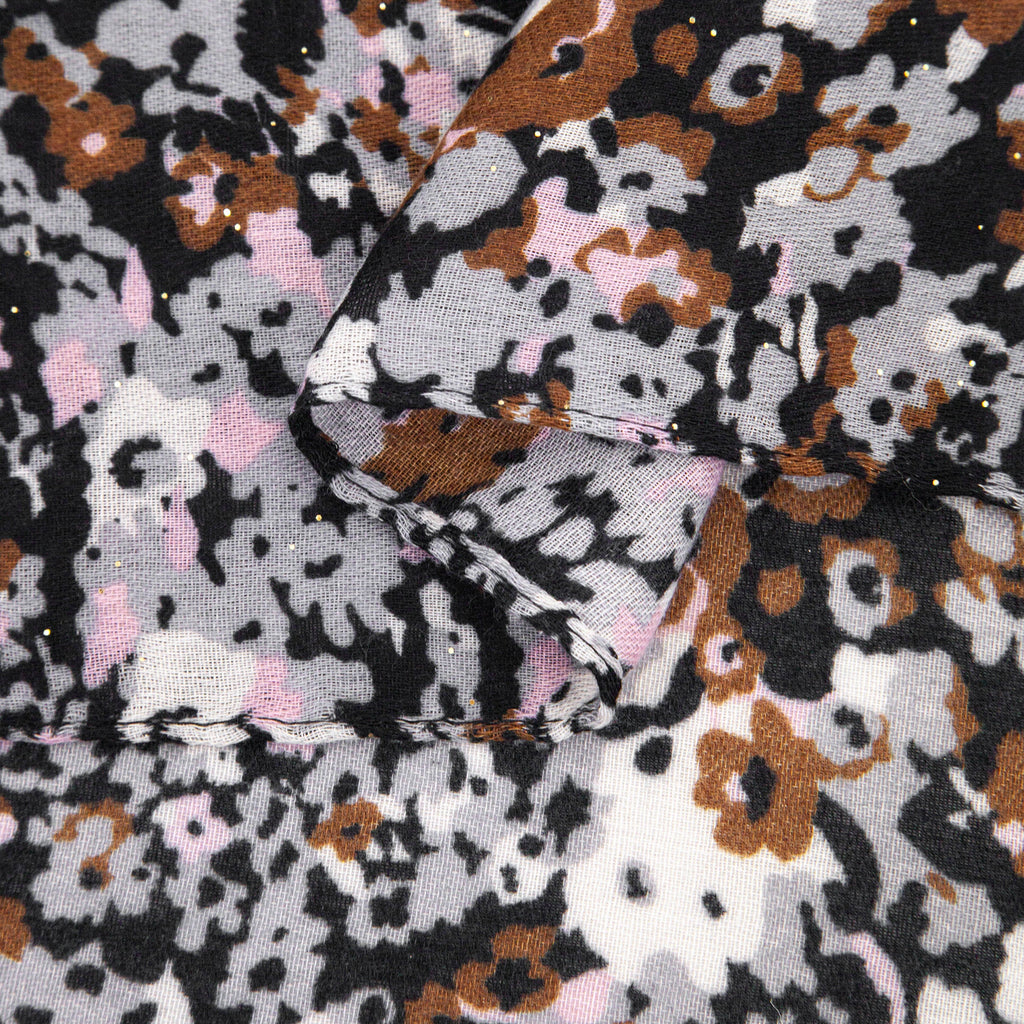 close up of the soft viscose fabric, the neutral floral print pattern is are clearly visible
